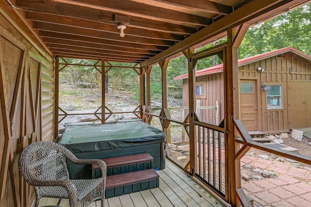 sunroom / solarium with a healthy amount of sunlight and a hot tub