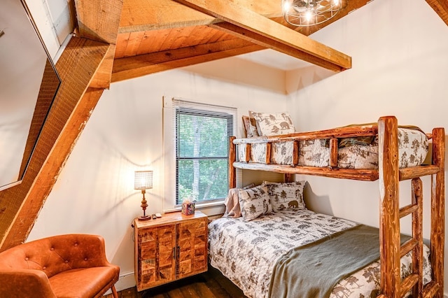 bedroom with dark hardwood / wood-style flooring and beamed ceiling