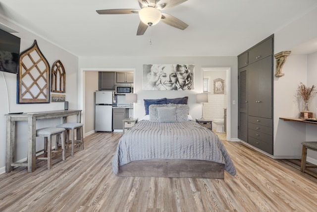 bedroom with light wood-type flooring, ceiling fan, white refrigerator, and a closet