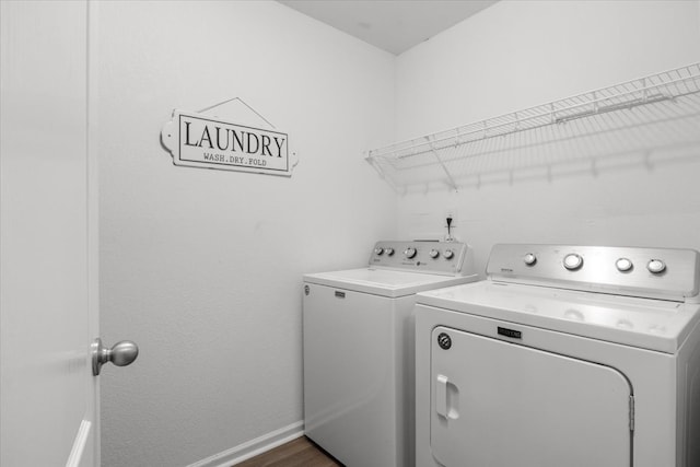 washroom featuring dark wood-type flooring and washing machine and clothes dryer