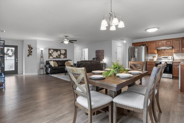 dining room with hardwood / wood-style floors and ceiling fan with notable chandelier