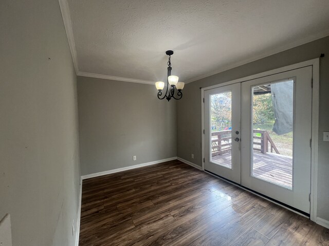 interior space featuring dark hardwood / wood-style floors, a textured ceiling, french doors, and a notable chandelier