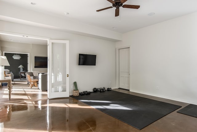 exercise room featuring concrete floors and ceiling fan