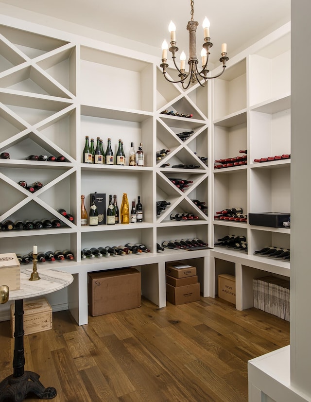 wine room featuring dark wood-type flooring and a chandelier