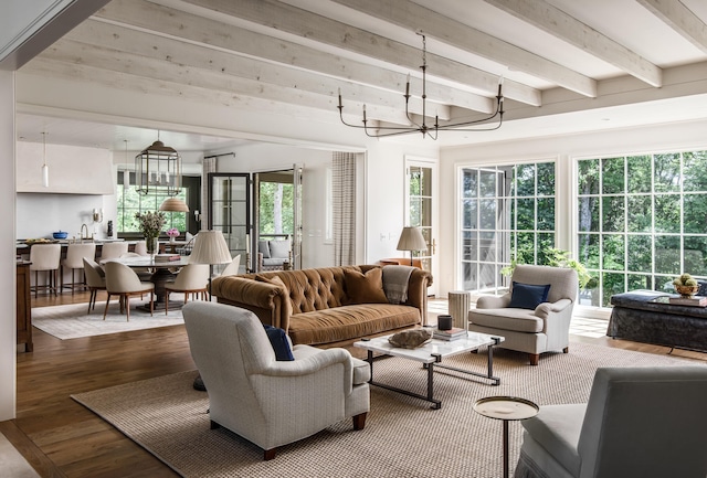 living room featuring hardwood / wood-style floors, a notable chandelier, and beam ceiling