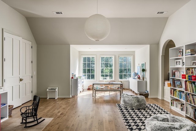 sitting room with light hardwood / wood-style flooring and vaulted ceiling