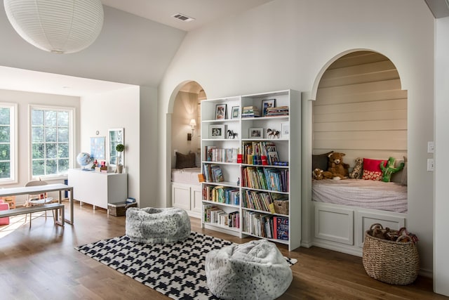 sitting room featuring dark hardwood / wood-style floors and high vaulted ceiling