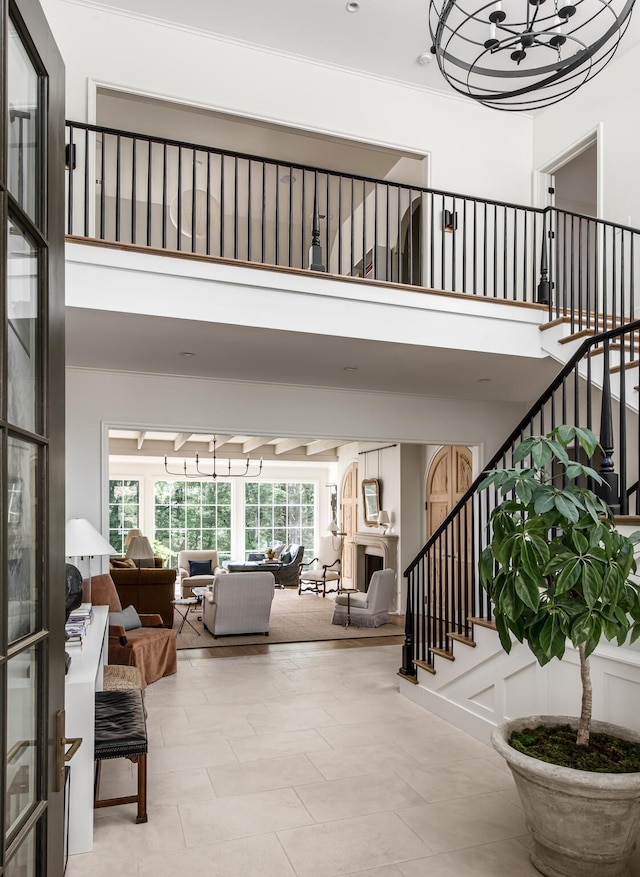 interior space featuring a towering ceiling and tile patterned flooring