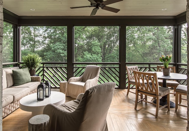 sunroom / solarium with ceiling fan and a healthy amount of sunlight