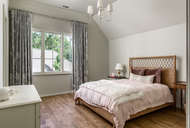 bedroom with lofted ceiling and light hardwood / wood-style flooring