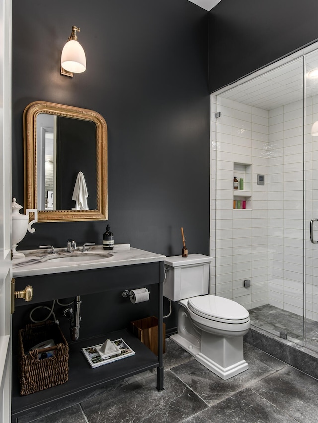 bathroom featuring toilet, vanity, and walk in shower