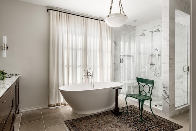 bathroom featuring independent shower and bath, vanity, and tile patterned flooring