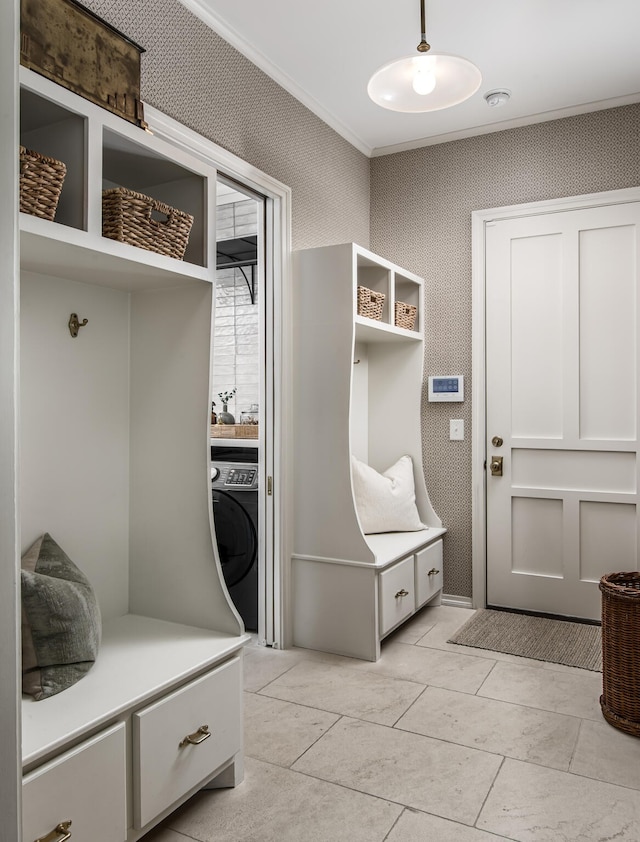 mudroom featuring washer / clothes dryer, light tile patterned flooring, and ornamental molding