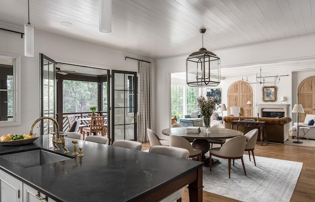 dining room featuring wooden ceiling, sink, dark hardwood / wood-style flooring, and ornamental molding