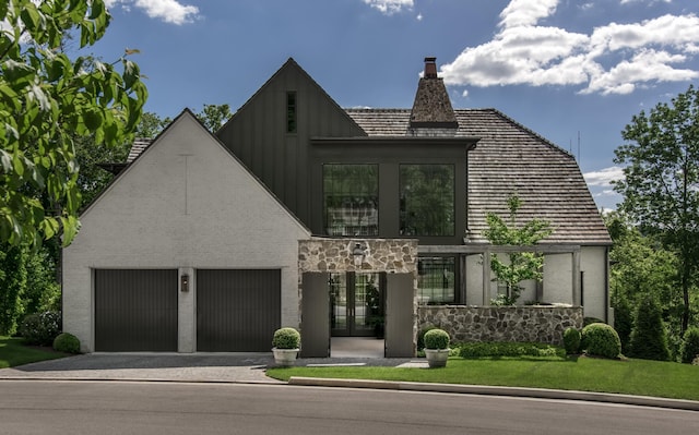 view of front of home featuring a garage and a front lawn