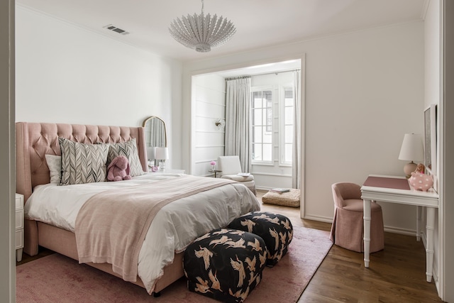 bedroom with dark wood-type flooring and crown molding