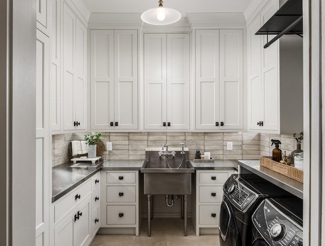 laundry room with sink, independent washer and dryer, and light tile patterned floors