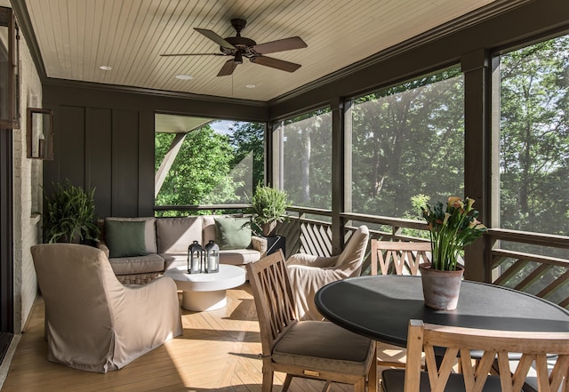 sunroom featuring plenty of natural light, ceiling fan, and wooden ceiling