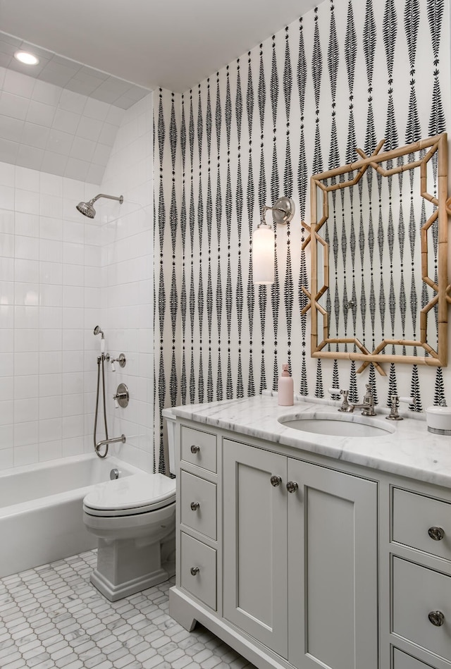 full bathroom featuring vanity, toilet, and tiled shower / bath