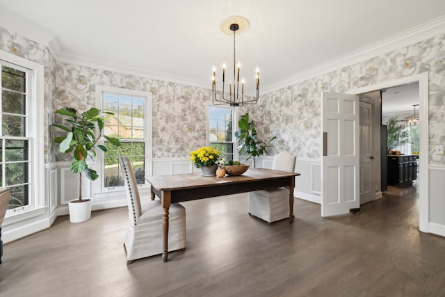 dining room featuring dark wood-type flooring, a chandelier, and crown molding