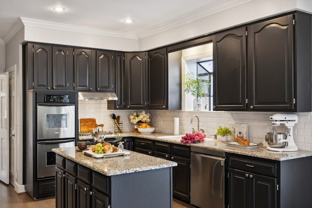 kitchen featuring stainless steel appliances, sink, tasteful backsplash, and ornamental molding