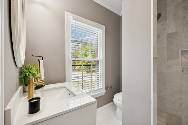 bathroom with tiled shower, vanity, tile patterned floors, and toilet