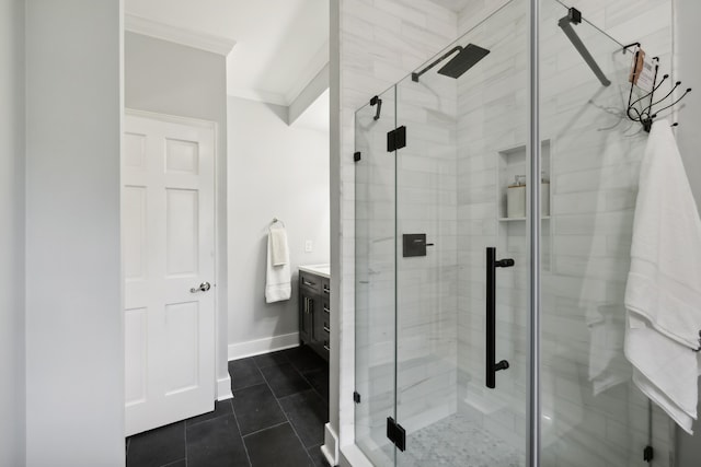 bathroom with a shower with door, vanity, tile patterned floors, and ornamental molding