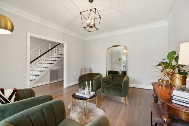 living room featuring dark hardwood / wood-style floors, crown molding, and a notable chandelier