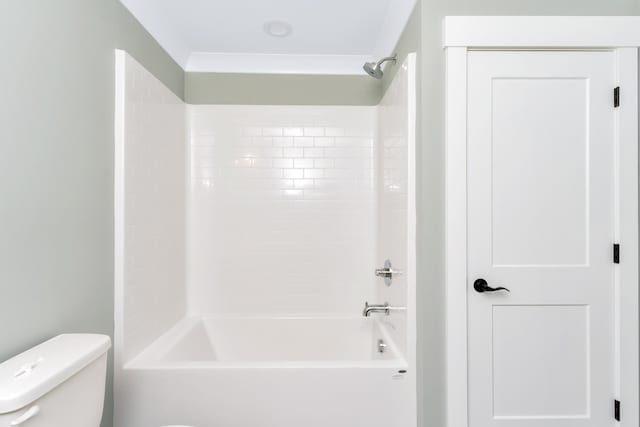 bathroom featuring tub / shower combination and toilet