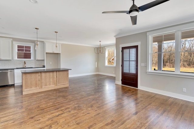 kitchen featuring dishwasher, white cabinetry, backsplash, ornamental molding, and decorative light fixtures