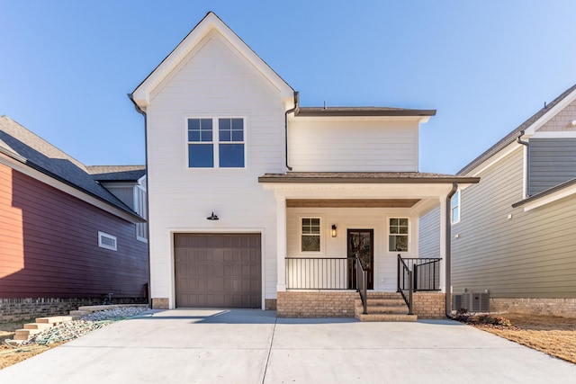 view of front of property featuring a porch, a garage, and central air condition unit