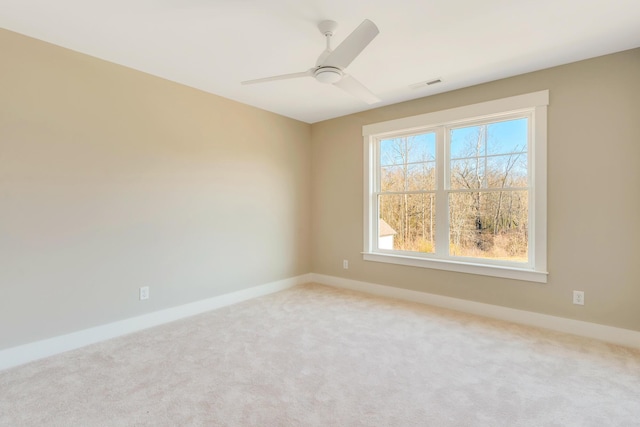 unfurnished room featuring ceiling fan and carpet flooring