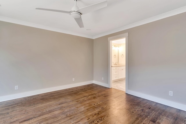 empty room with ornamental molding, dark hardwood / wood-style floors, and ceiling fan