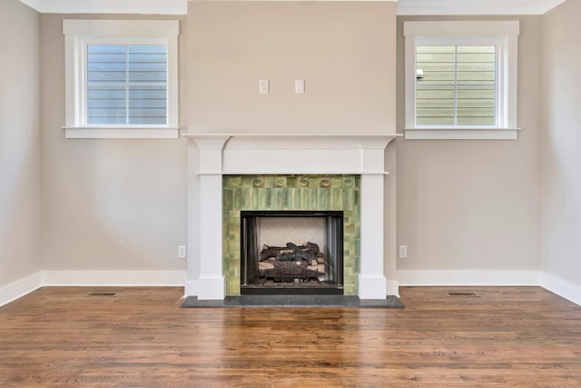 unfurnished living room with a fireplace and hardwood / wood-style floors