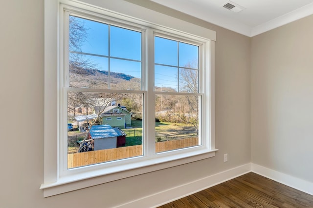 room details with ornamental molding and hardwood / wood-style floors