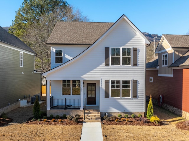 view of front property featuring central AC unit and covered porch