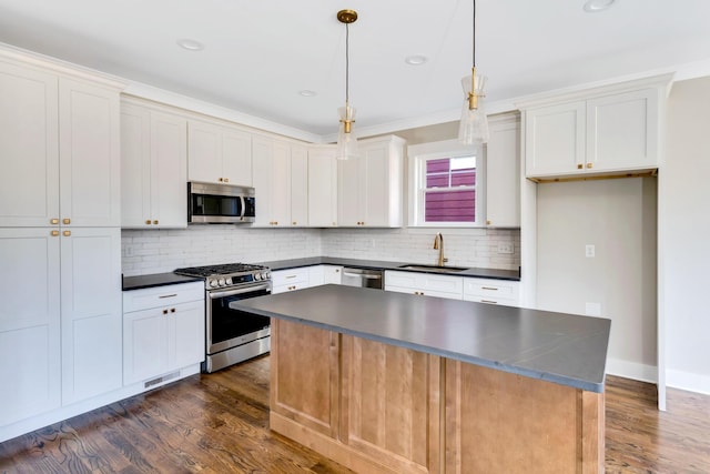 1297 Thomas Ave, Chattanooga, TN 37409 - kitchen featuring appliances with stainless steel finishes, dark countertops, dark wood-type flooring, tasteful backsplash, and recessed lighting
