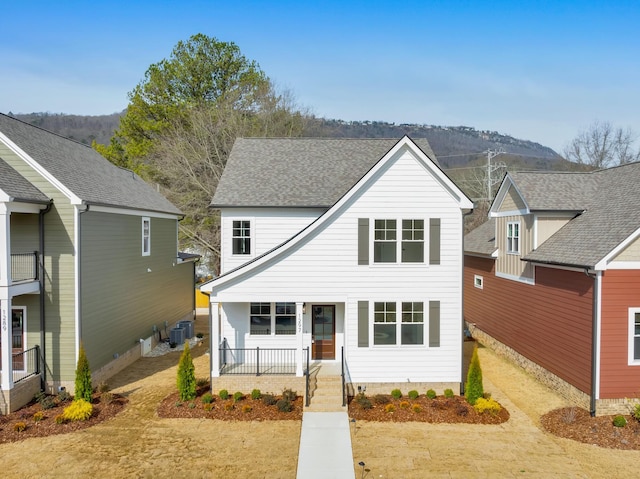 view of front of house with cooling unit and a porch