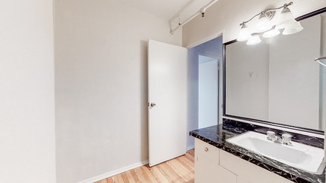 bathroom with vanity and hardwood / wood-style flooring