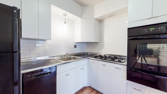 kitchen featuring white cabinetry, sink, black appliances, and decorative light fixtures