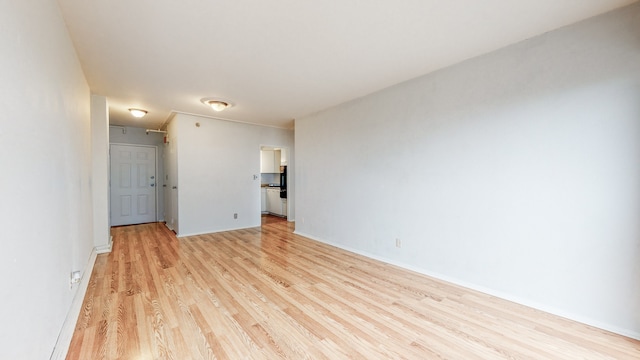 spare room with light hardwood / wood-style flooring