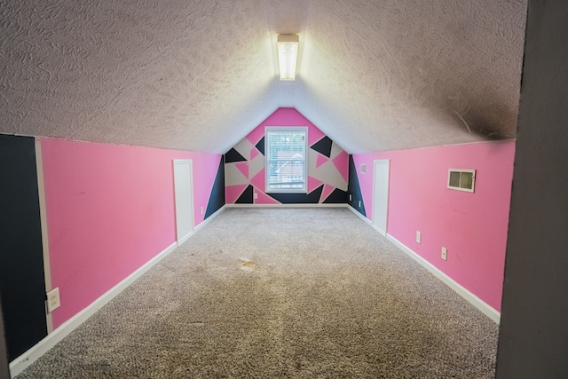 bonus room featuring a textured ceiling, vaulted ceiling, and carpet