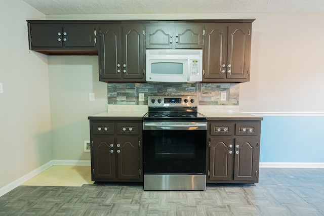 kitchen with backsplash, stainless steel range with electric cooktop, and dark brown cabinetry