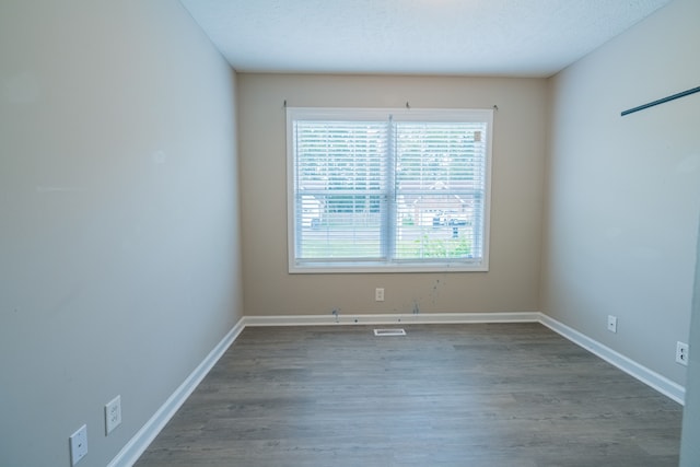 unfurnished room featuring a textured ceiling and hardwood / wood-style flooring