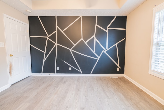 unfurnished room featuring hardwood / wood-style flooring and plenty of natural light