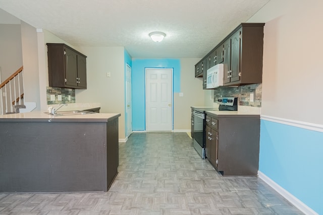 kitchen featuring dark brown cabinets, a textured ceiling, stainless steel range with electric stovetop, and light parquet floors