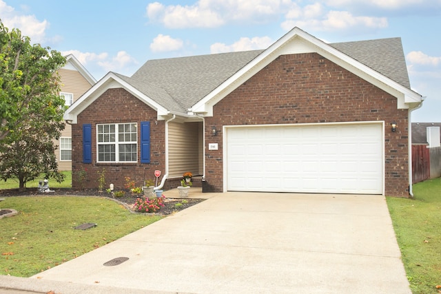 view of front of property featuring a garage and a front yard