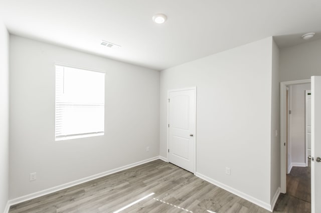 spare room featuring plenty of natural light and light wood-type flooring