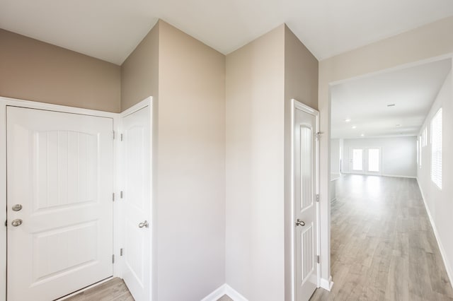 hallway with light hardwood / wood-style floors