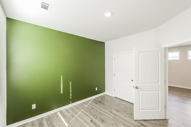 spare room featuring light wood-type flooring